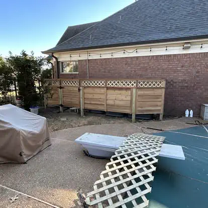 A wood privacy screen with a lattice top