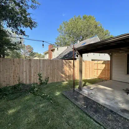 A cedar privacy fence along a covered back patio