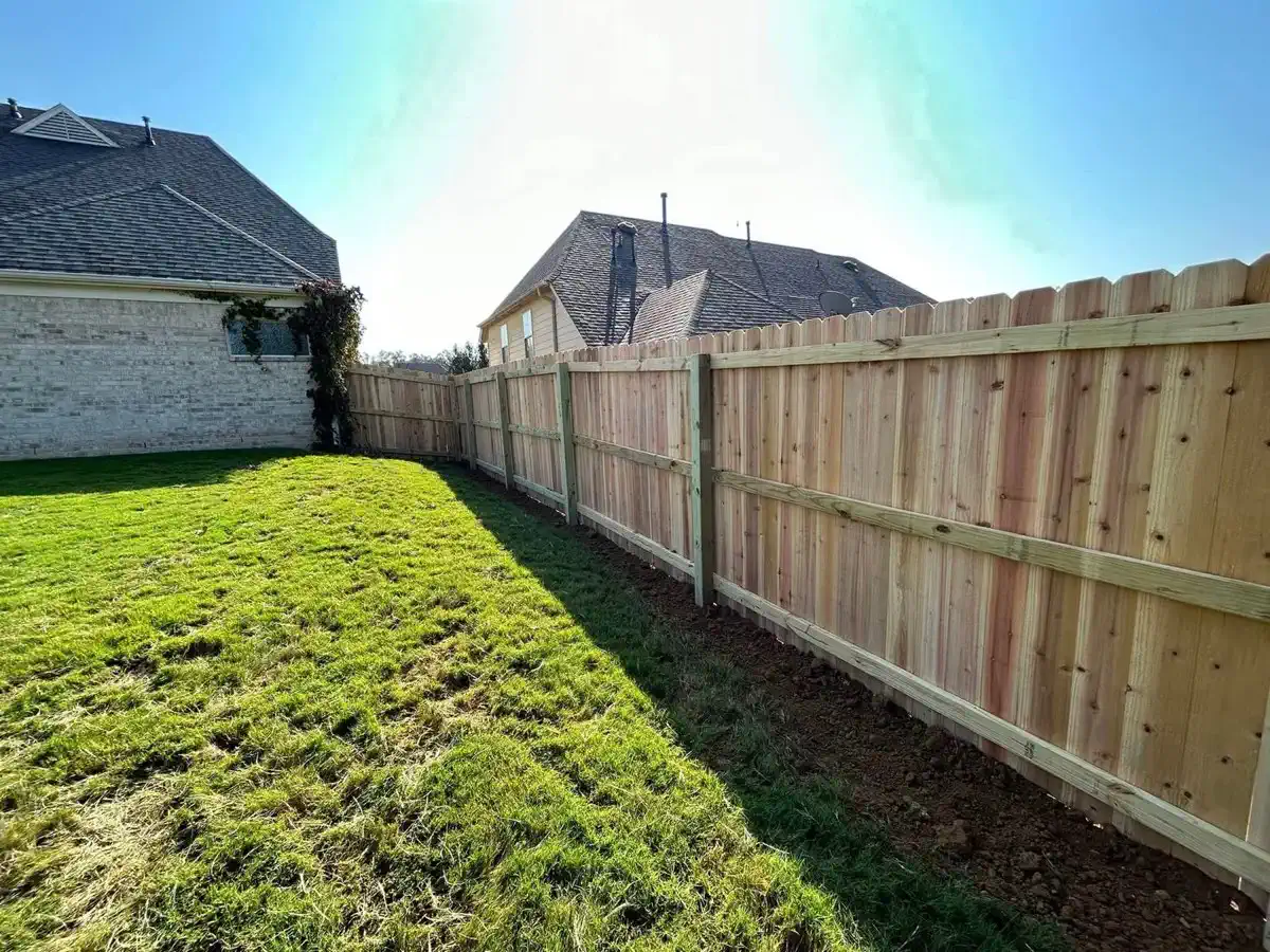 A long wood privacy fence along a yard